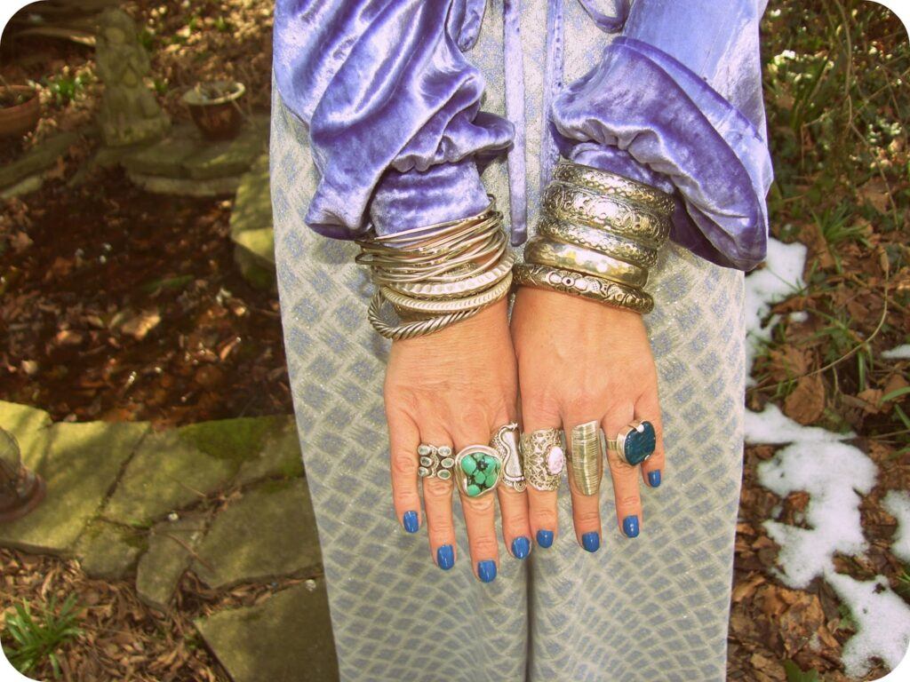Arms and hands of girl with lots of jewelry