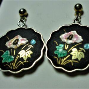 Scalloped round earrings, black background, inlaid pink flower