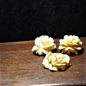 3 celluloid roses