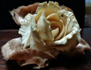 Single celluloid rose, velvet leaves